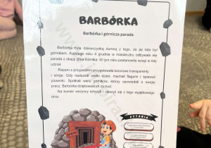 Dzieci słuchają krótkiego opowiadania pt. „Barbórka”.