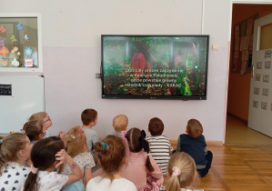 Dzieci z grupy Odkrywcy podczas oglądania filmu na temat historii czekolady.