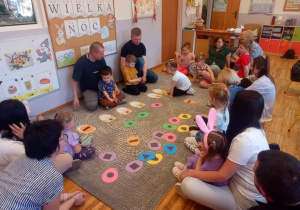 Dzieci podczas zabawy w segregowanie pisanek według wzoru i koloru.