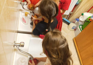 Dzieci myją jabłka.