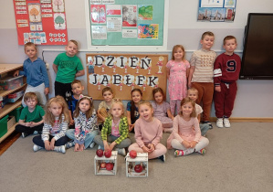 Na zdjęciu pozują dzieci z grupy Odkrywcy z jabłkami.