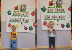 Fotografie dzieci z jabłkami w rączkach na tle tablicy dekoracyjnej z okazji Dnia Jabłka
