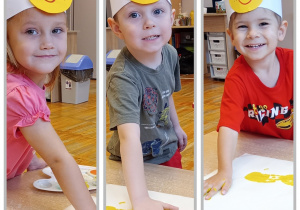 Kolaż z dziećmi obijającymi pomalowane dłonie na kartonie.