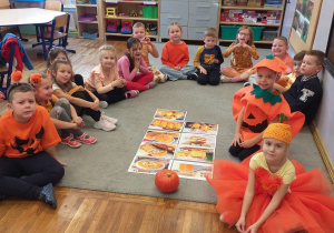 Zdjęcie przedstawia dzieci poznające różne wyroby z dyni.