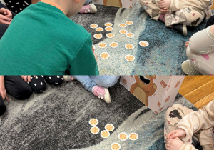 Smerfy rozwiązują ćwiczenia matematyczne i karmią miodkiem Misia.