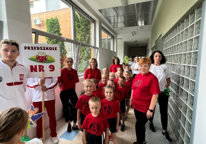 Reprezentacja przedszkola czeka w szatni hali sportowej dumnie z Panią Dyrektor na uroczystą prezentacje drużyn.